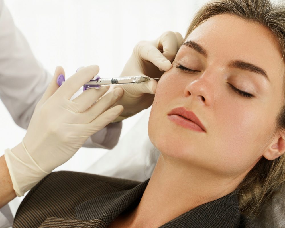 Female client during facial filler injections in aesthetic medical clinic in New York, NY | Re:forma